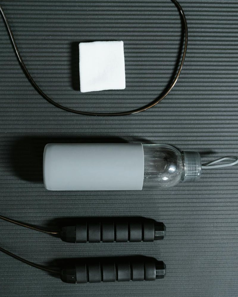 Top view of exercise mat with water bottle and towels