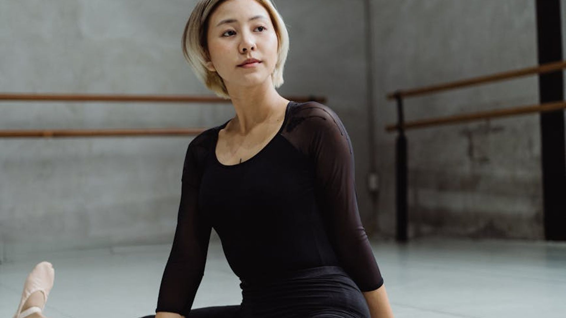 Woman performing elegant stretches in a bright minimalist room